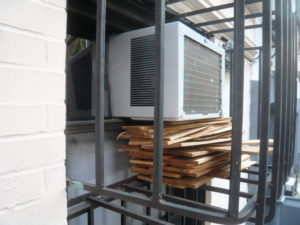 AC Window unit on wood slats