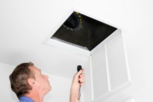 Technician Looking At Air Ducts